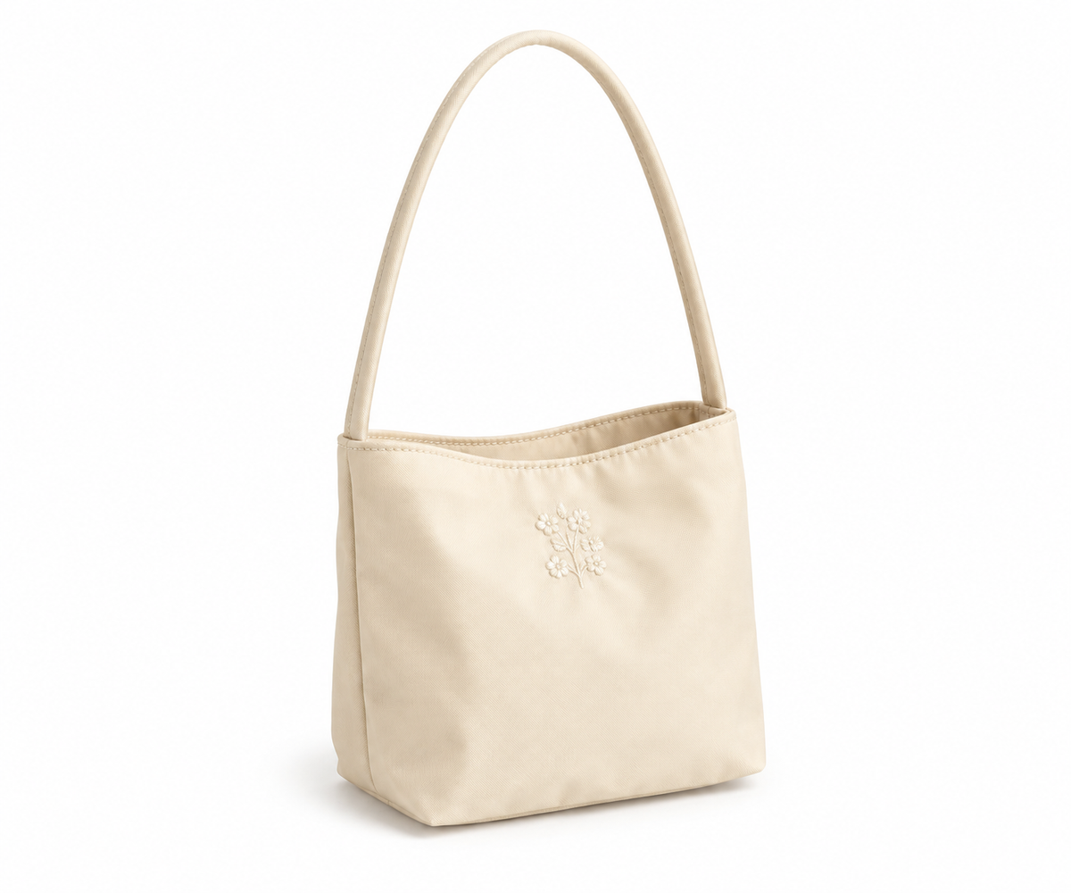 Beige embroidered Oxford bucket shoulder bag on a white background