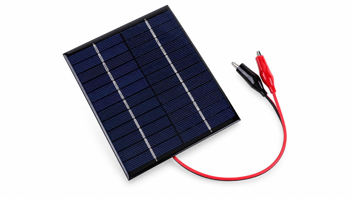 Mini solar panel with alligator clips on white background